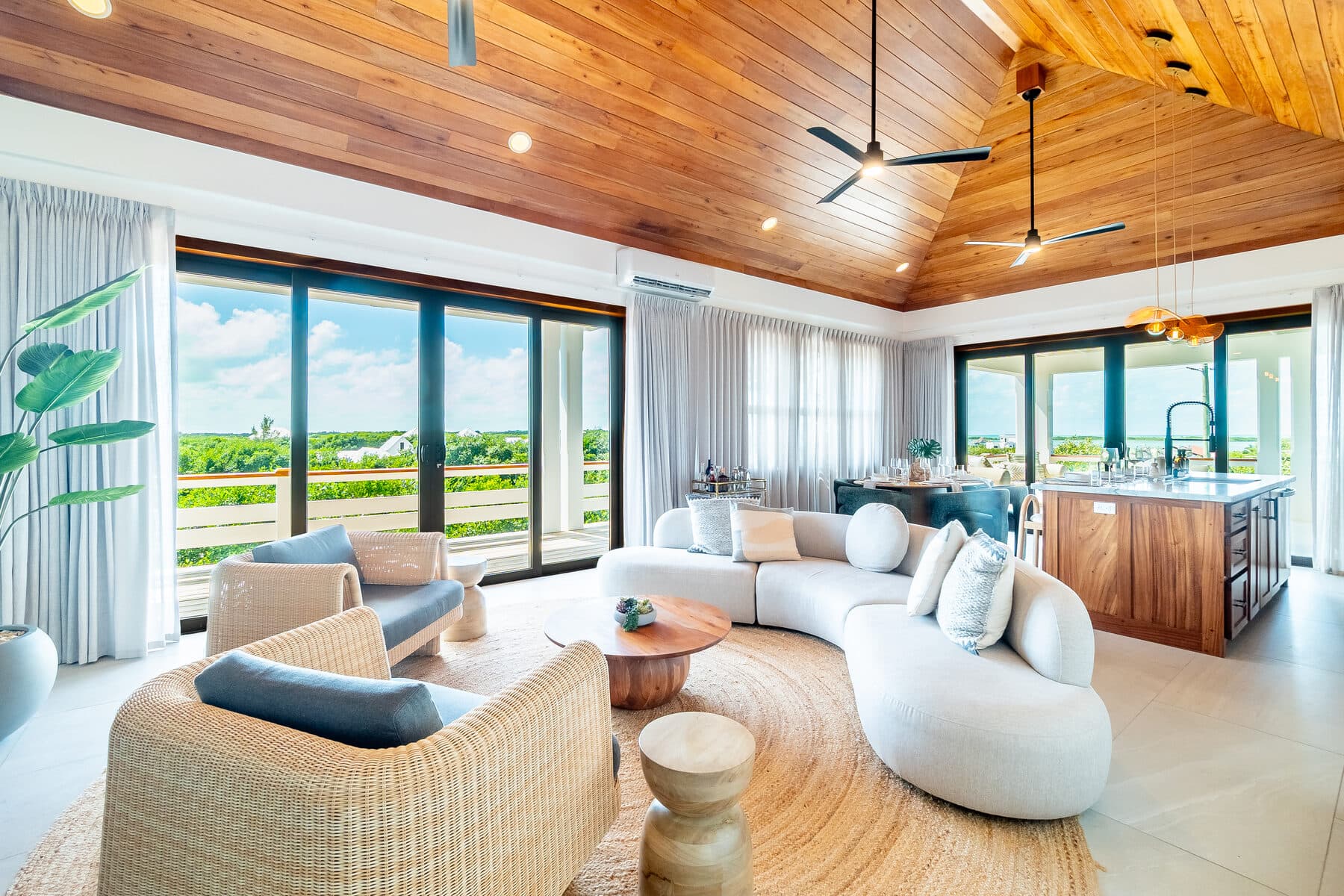 Penthouse living area with a vaulted timber ceiling at BelaDia, Belize